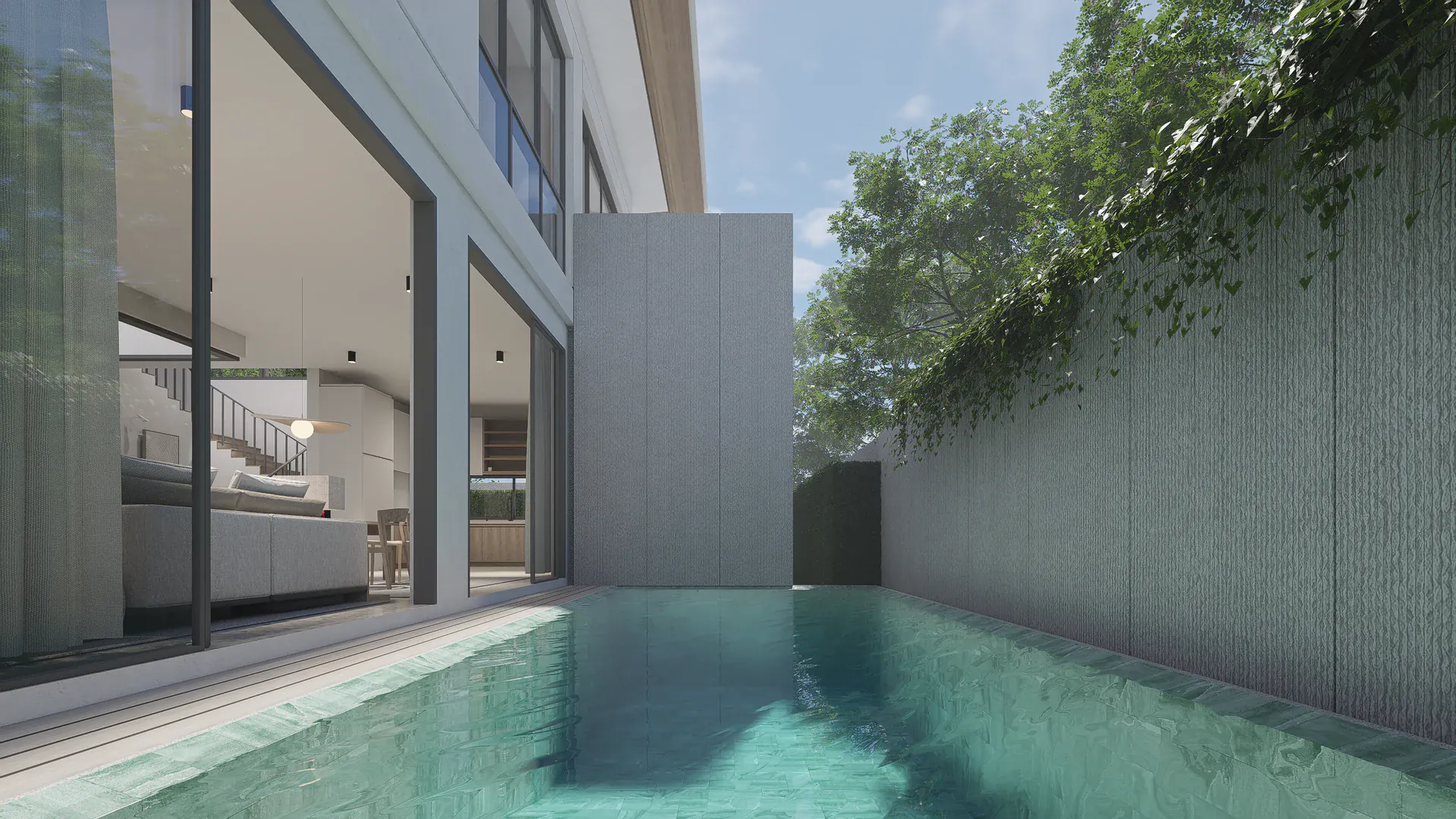 Daytime pool view along the side boundary, framed by the glazed living area, a solid privacy wall and overhanging planting.