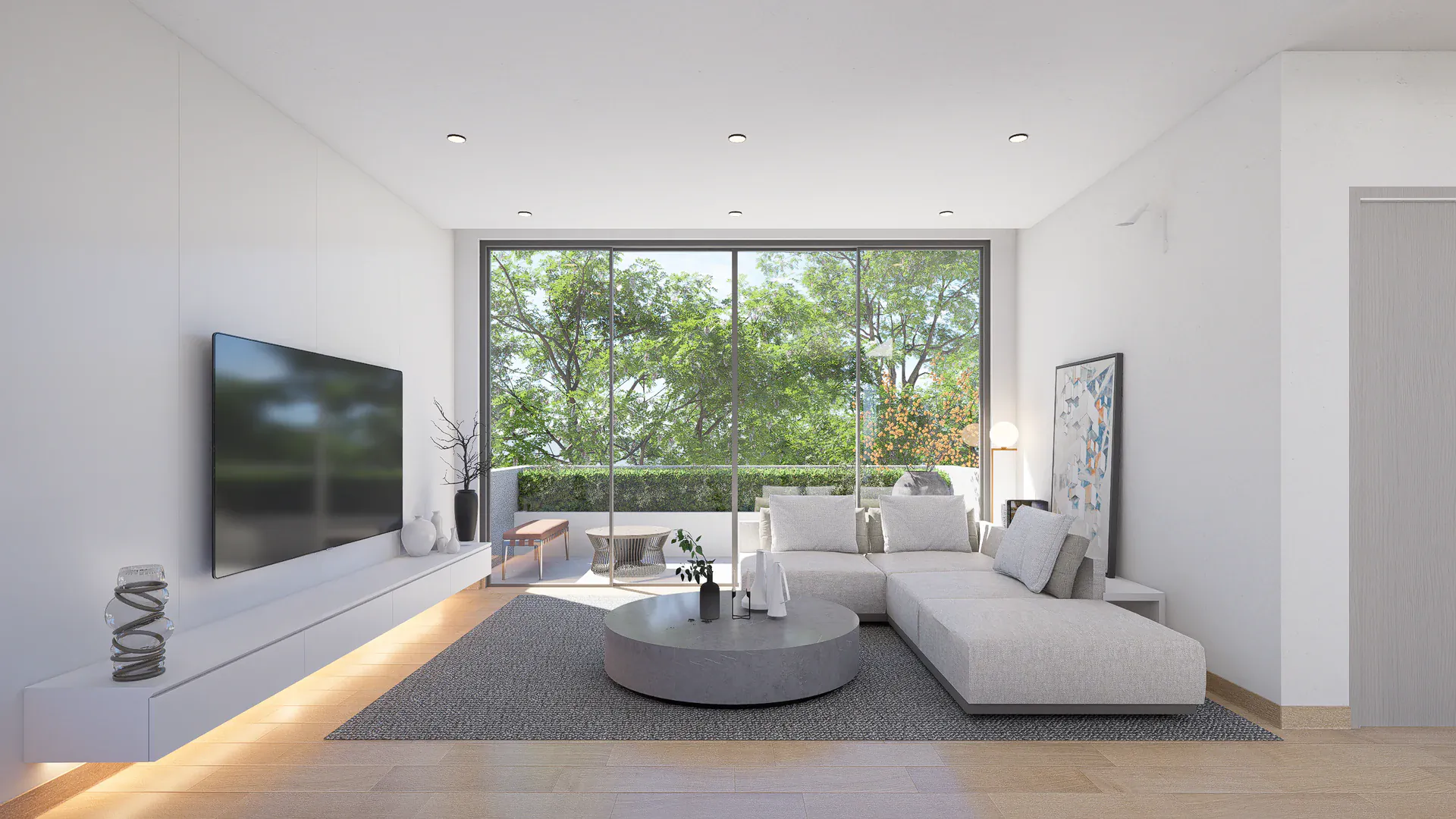Private upper-floor sitting area with a broad window and integrated low storage overlooking the planted surroundings.