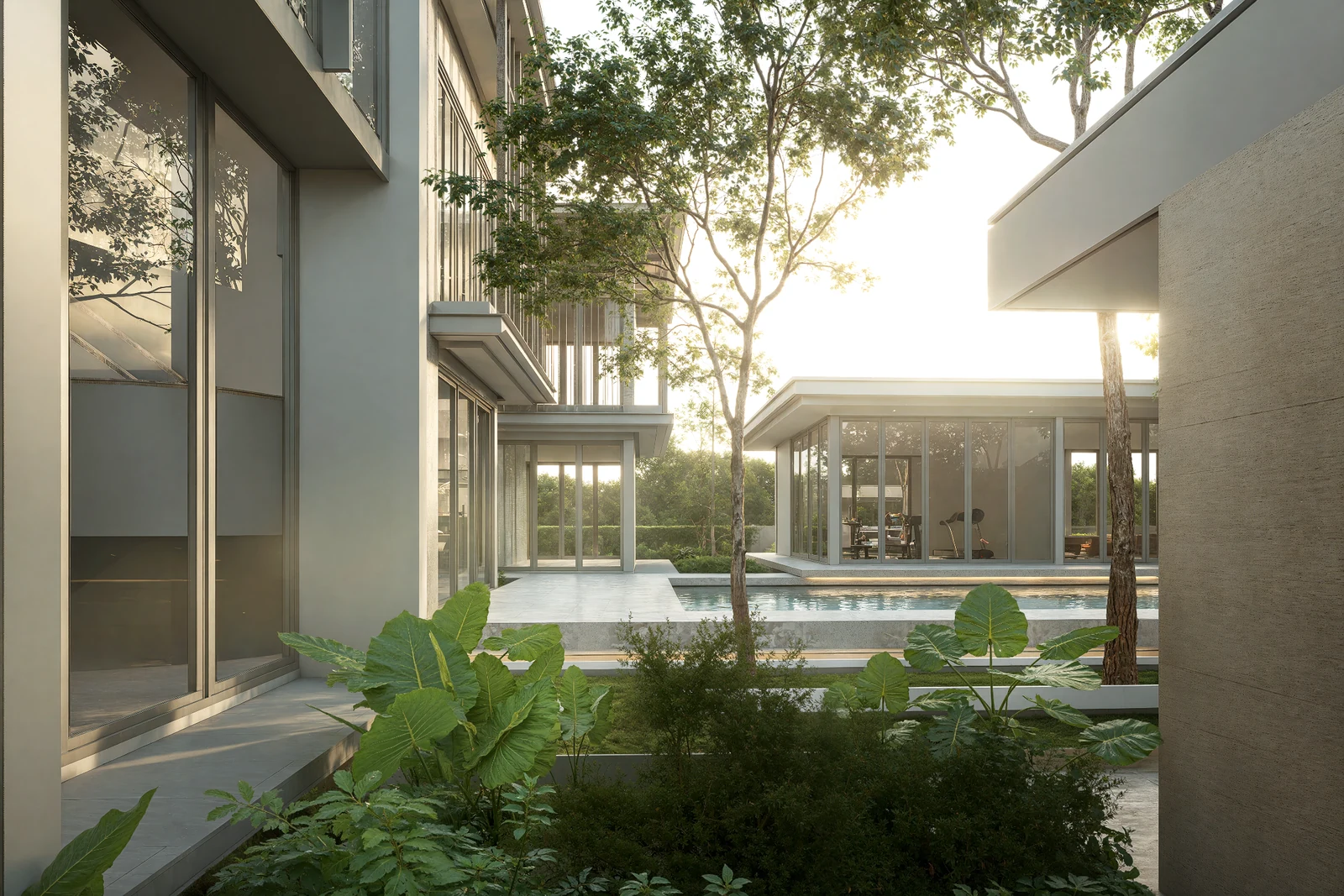 Trees and planting between glazed buildings and the pool at BANG BUA THONG.