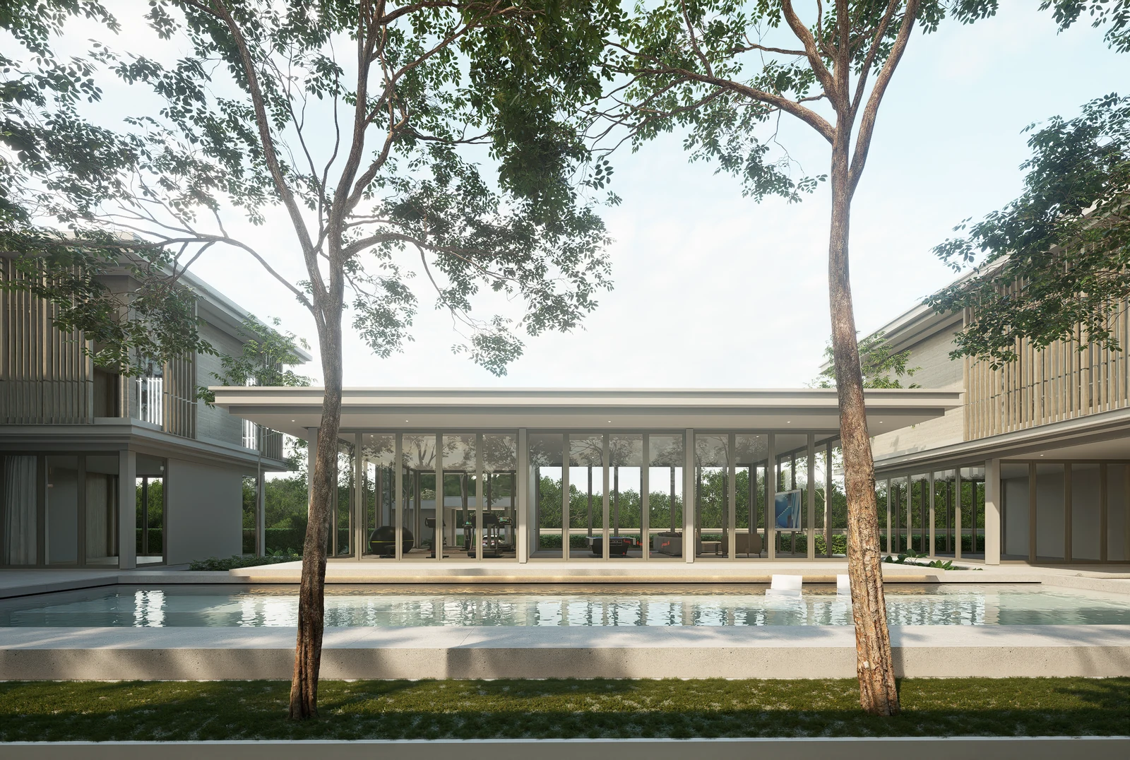 Pool and single-storey clubhouse between two-storey residences at BANG BUA THONG.